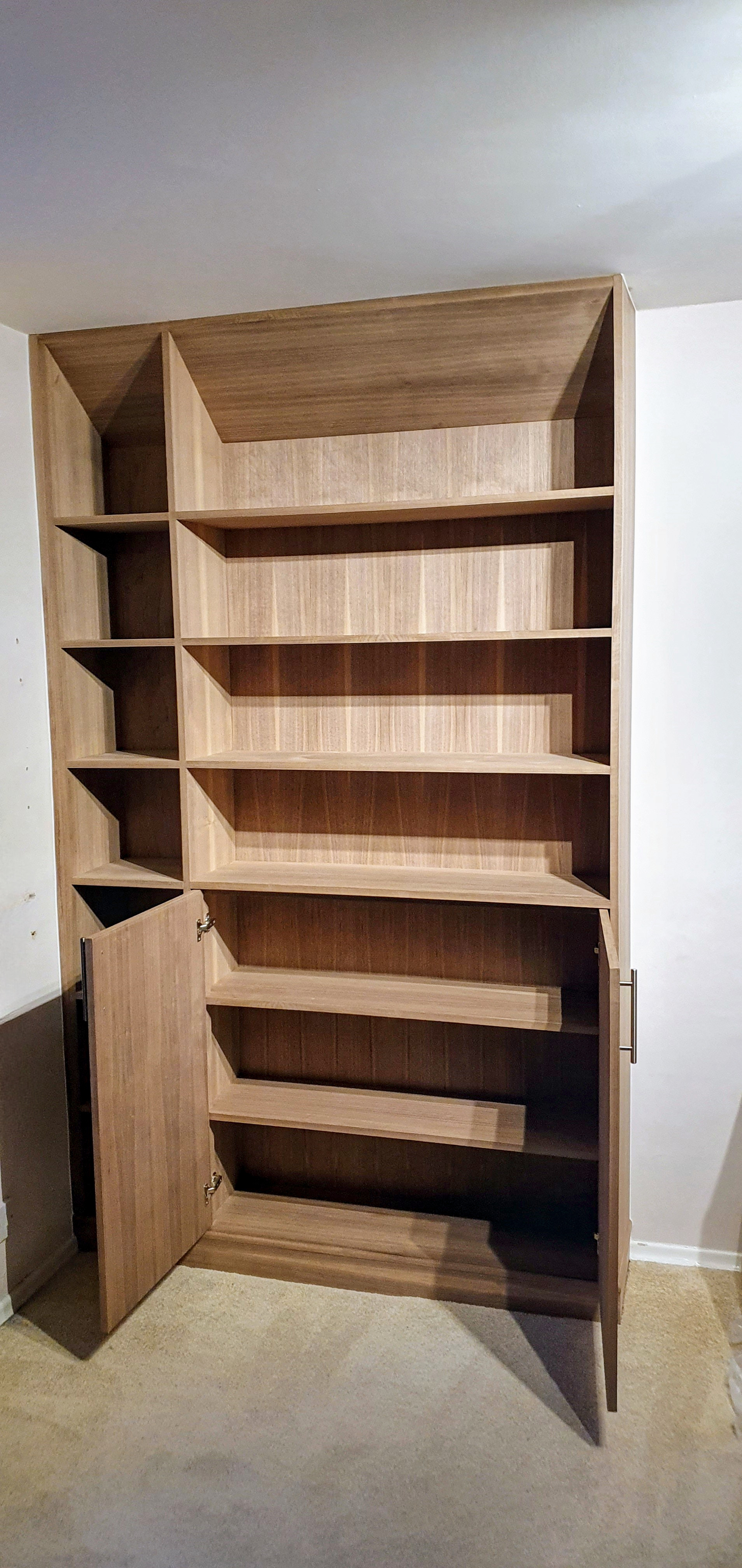 Custom walnut bookcase with concealed storage