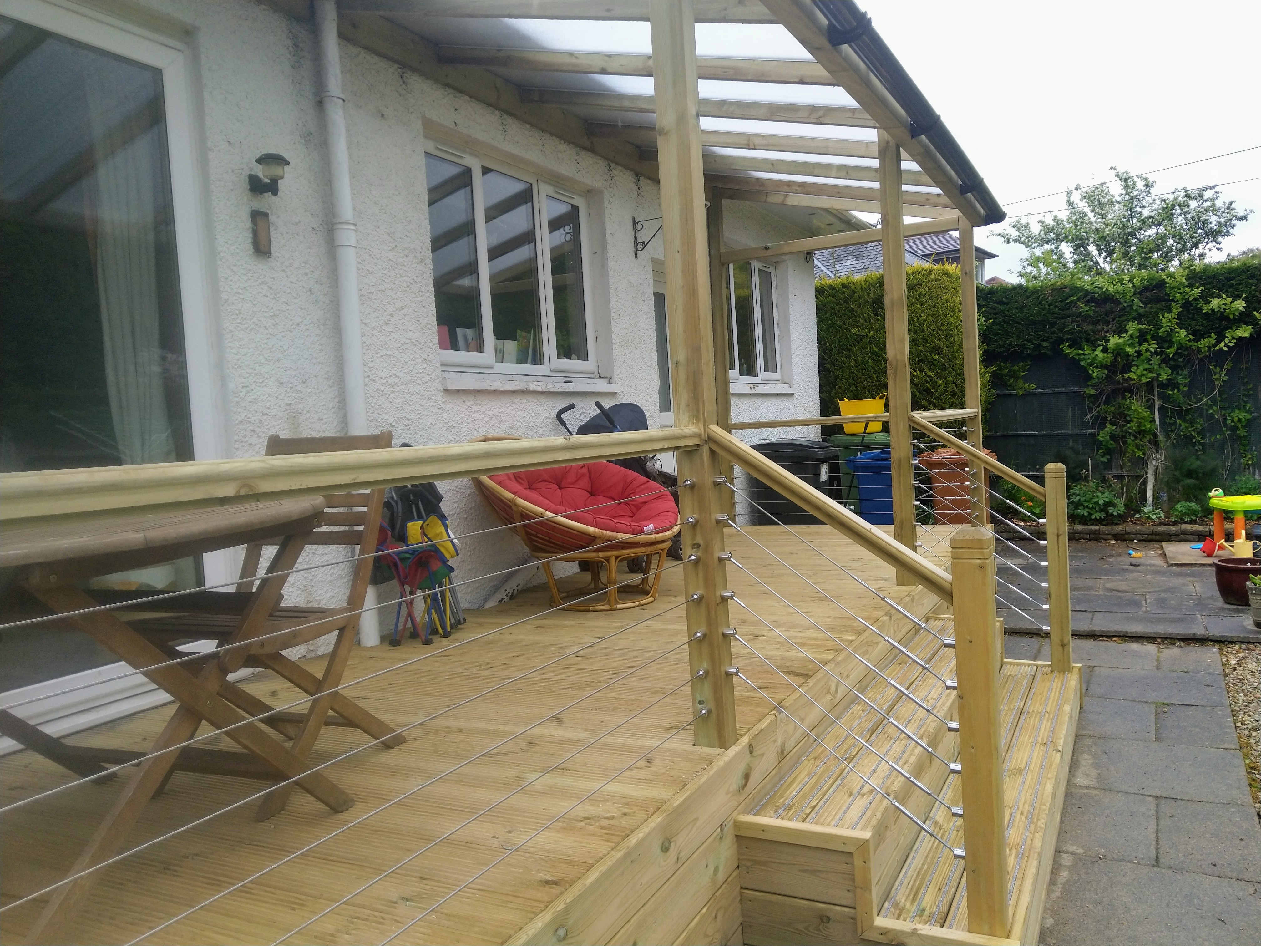 Custom garden decking with integrated timber pergola roof